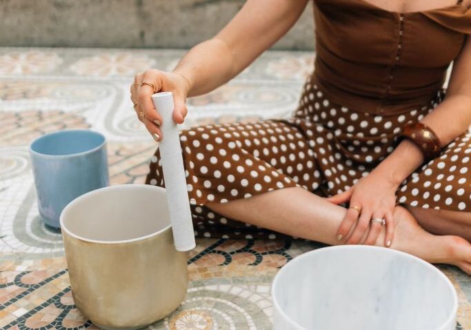 A woman wearing brown dress working on a pot